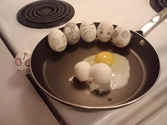 painted egg faces on a pan