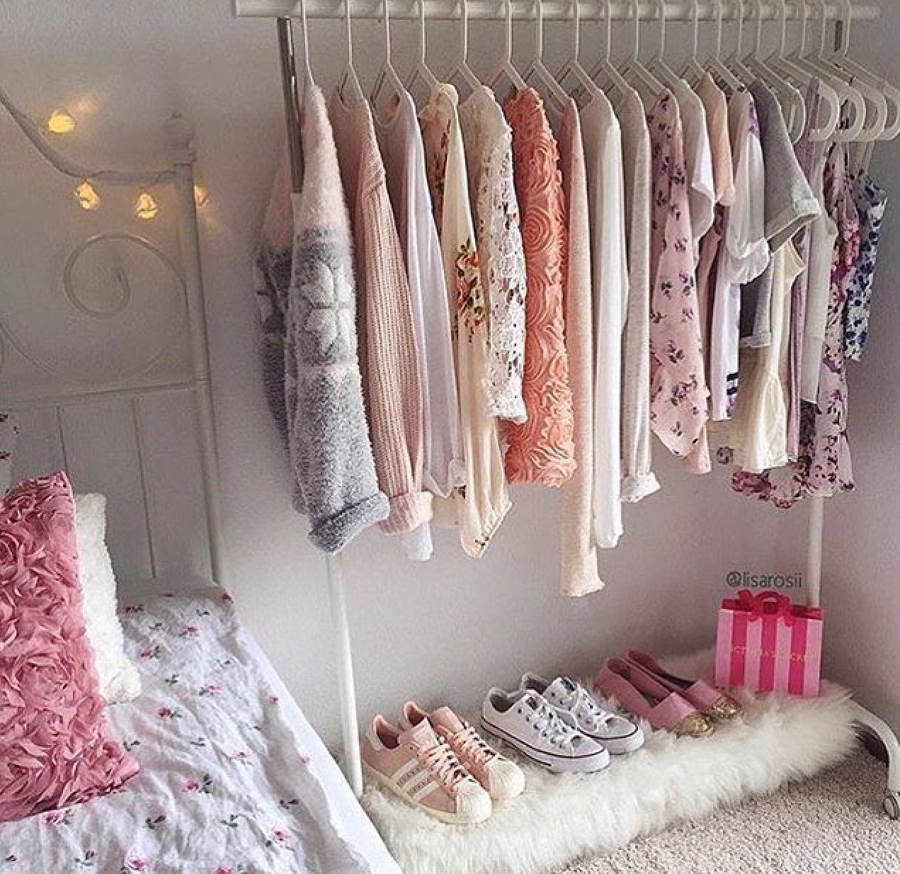 Coat rack with clothes in pink tones