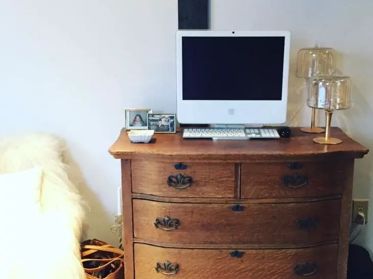Apple computer on a chest of drawers