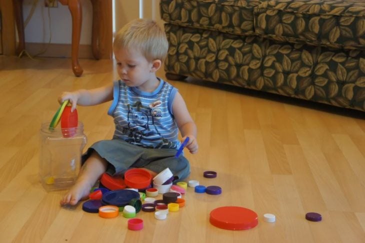 Boy playing with colorful lids