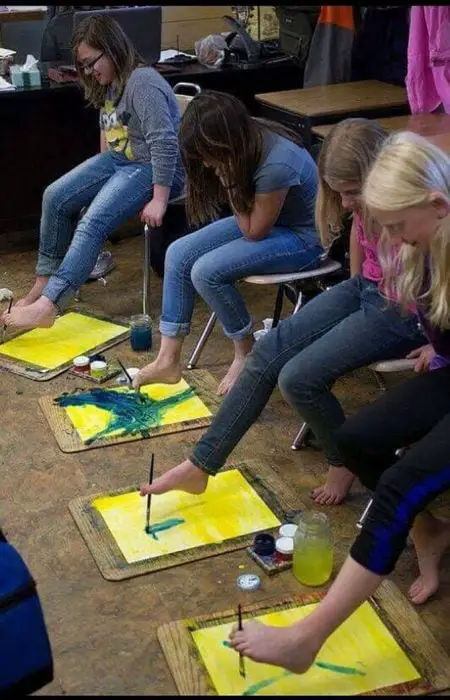 Children painting with their feet 