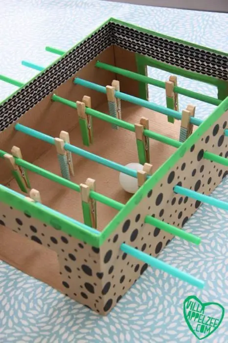 Foosball made of box, clothespins and straws