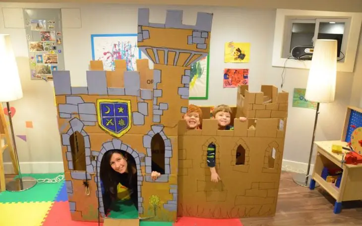 Kids and mom in cardboard castle