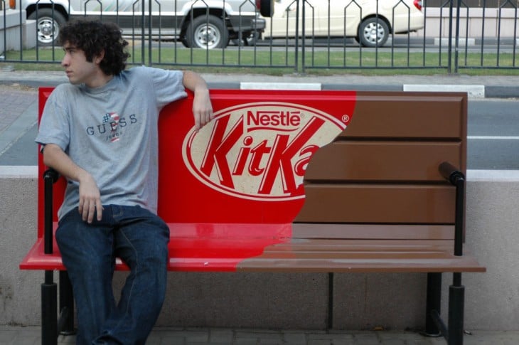 KitKat Nestlé chocolate shaped bench and a boy sitting on it 