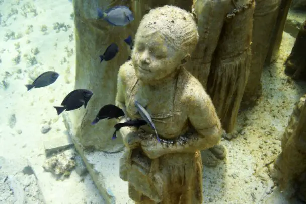 Statue Of Girl Kigando With Fish