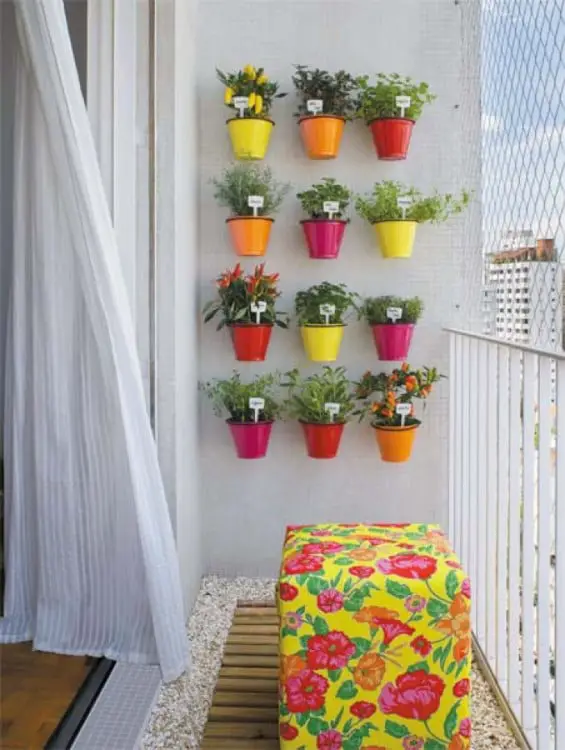 Small jars fixed on the wall like a vertical garden 