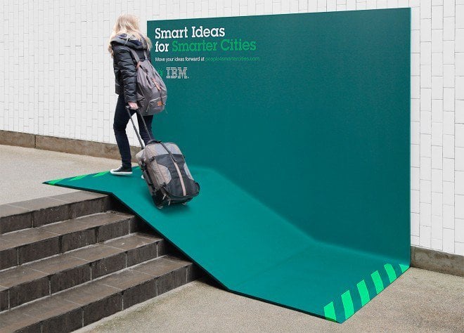 Woman passing by a ramp and poster advertising IBM 
