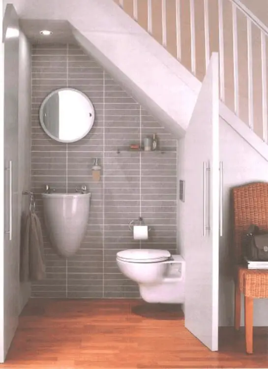 bathroom under the stairs of a house 