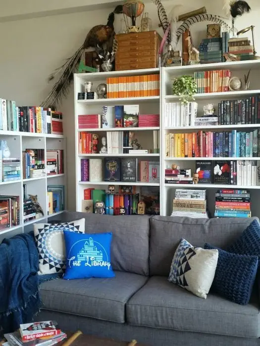 bookshelves behind a gray armchair