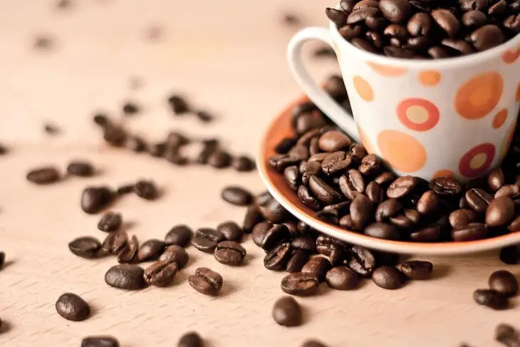 coffee beans in a cup with orange dots