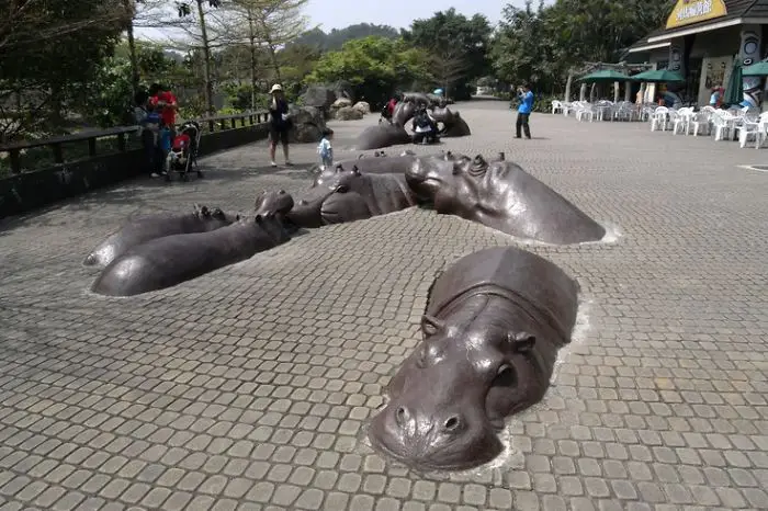 sculpture of Hippos coming off the street in China