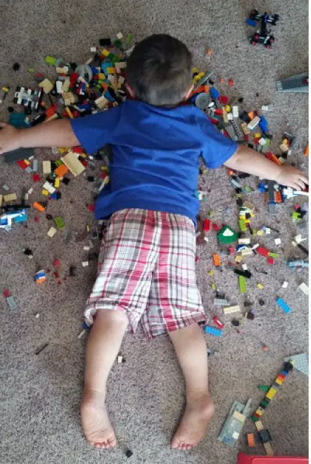BOY ASLEEP ON HIS LEGOS