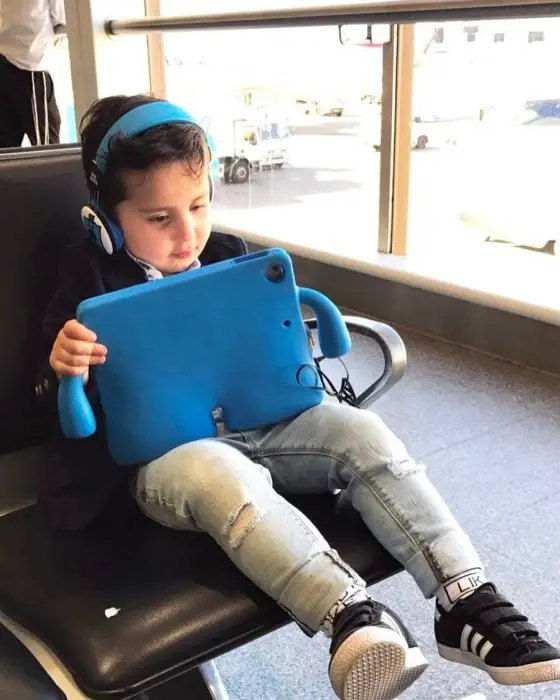 Child with tablet at airport