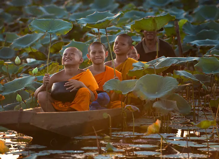 Children in canoe dressed in orange suits