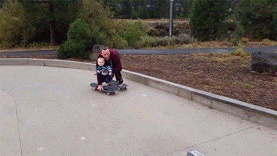 Father Teaches His Son How to Skateboard