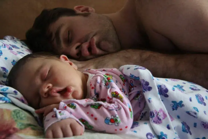 Father and daughter asleep in the same pose 
