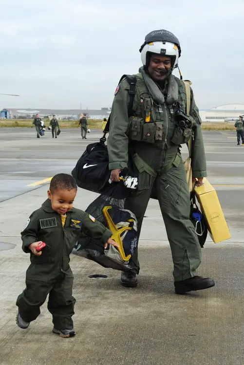 Father and son dressed as pilots at an airport 