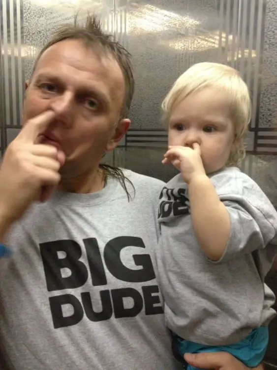 Father and son with finger on nose 