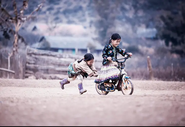 Girls playing with a bicycle