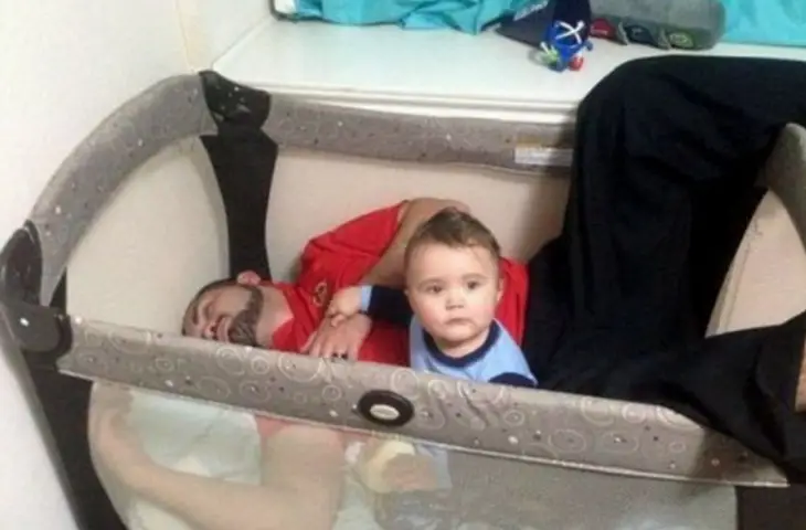 Man asleep inside his baby's crib 