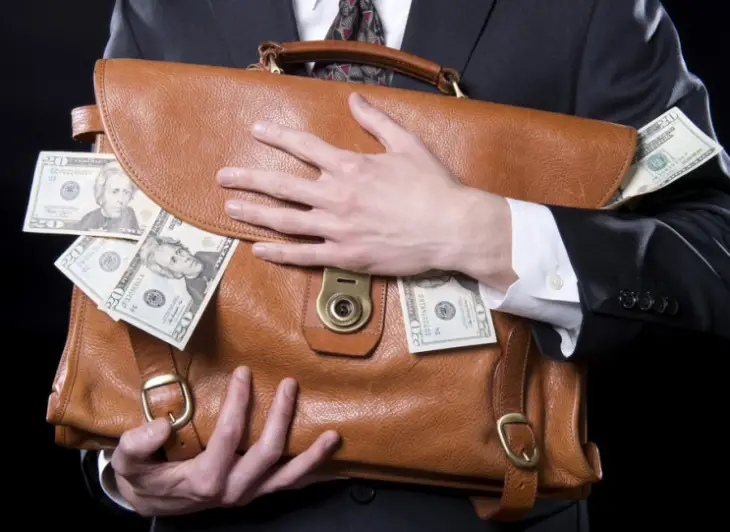 Man holding briefcase with money