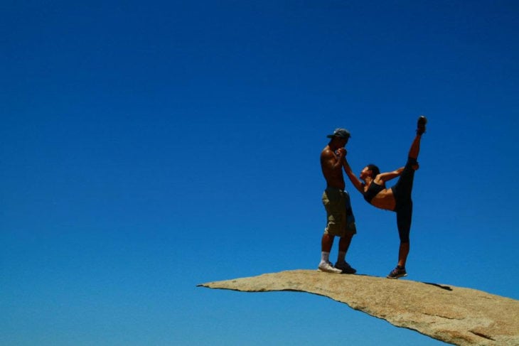 People stretching on a rock
