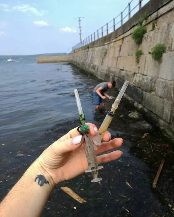 Plastic syringes in a polluted river