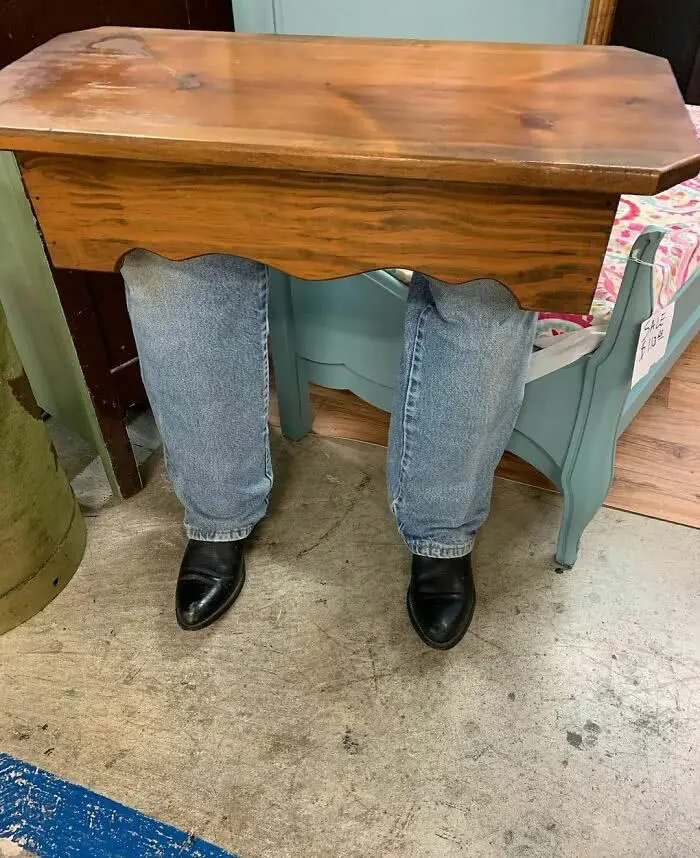 Wooden table with human legs