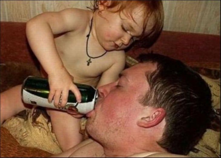 baby giving his father a canned drink 