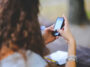 Woman Typing On Cell Phone