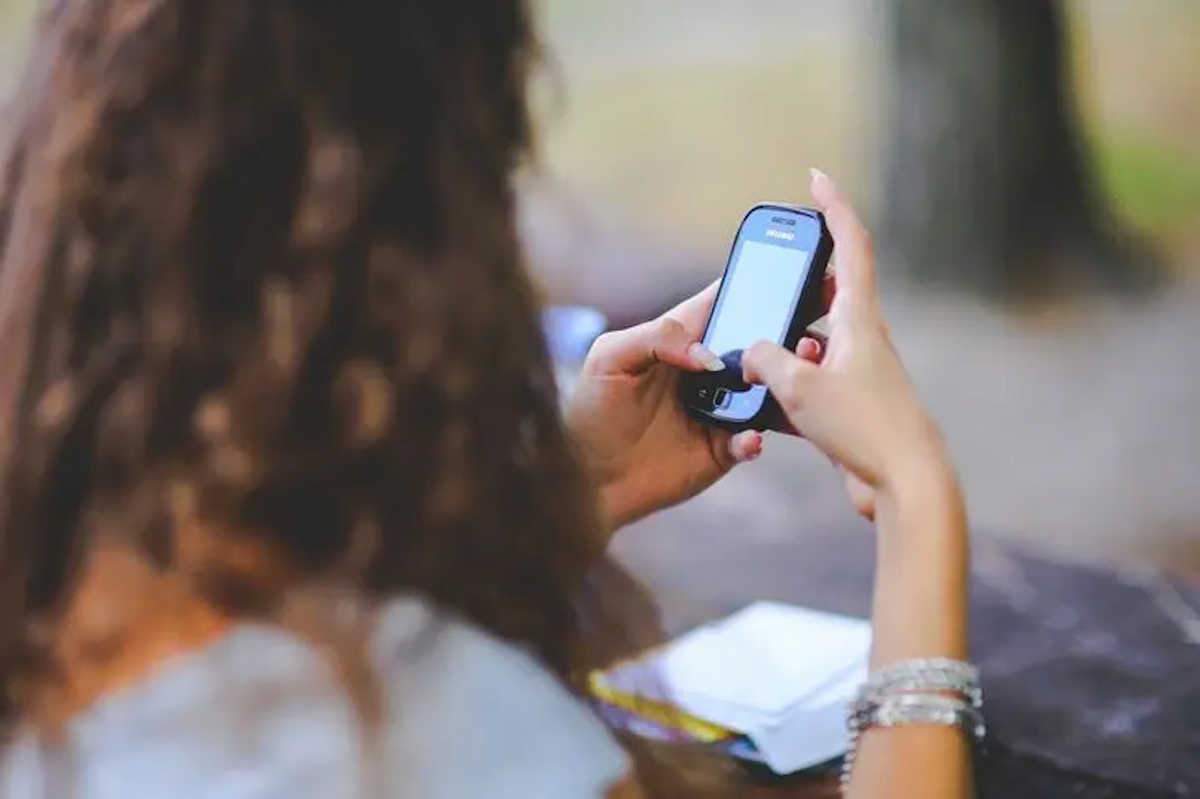Woman Typing On Cell Phone