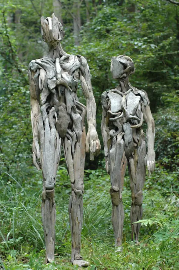 Wooden humanoid sculptures in the forest